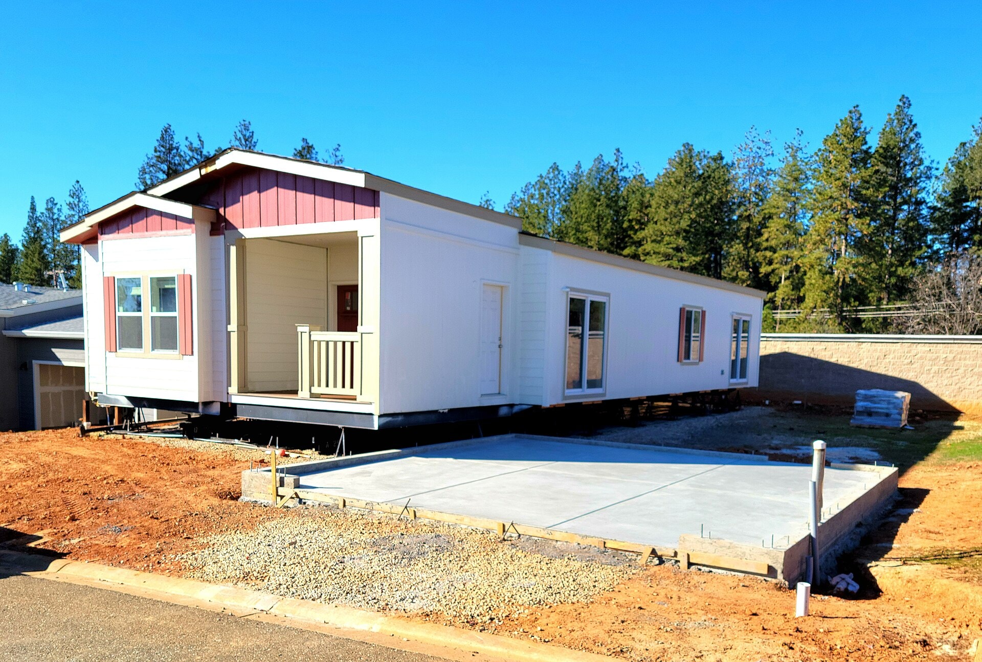 A newly set manufactured home on a freshly prepared lot, leveled and tied down by SetCo